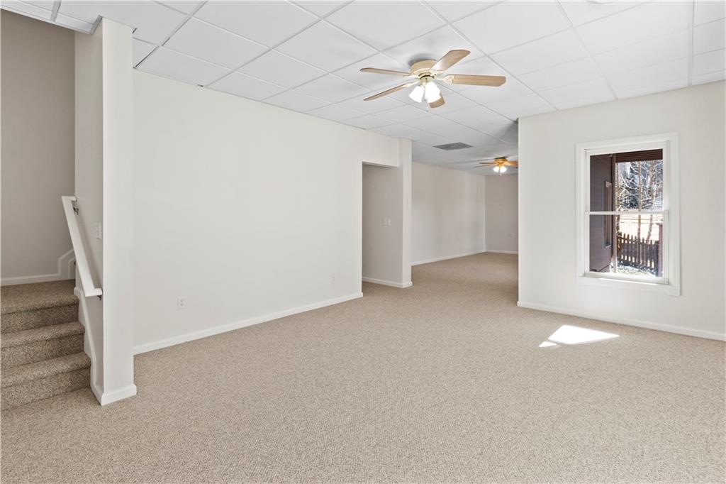 325 Morning Mist Walk Suwanee, GA 30024 - Photo 39 of 67 an empty room with chandelier fan and windows