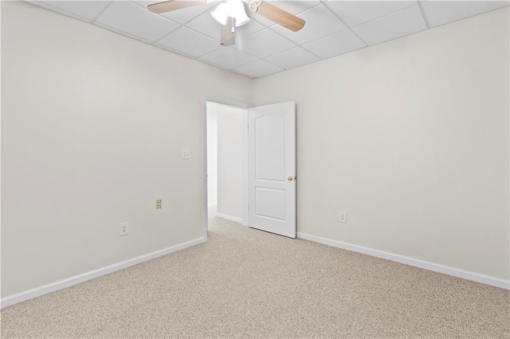 325 Morning Mist Walk Suwanee, GA 30024 - Photo 46 of 67 an empty room with a chandelier fan