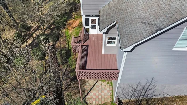an aerial view of a house with a yard and lake view