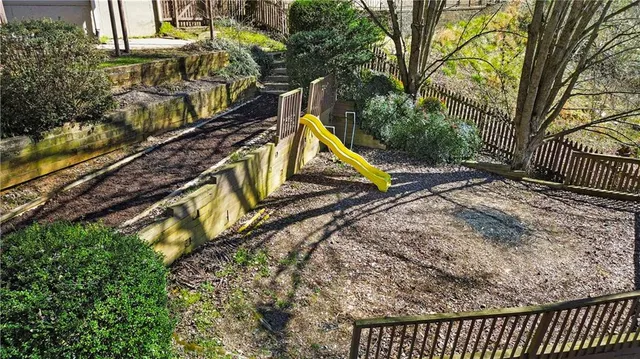 an aerial view of a house with outdoor space and a lake view