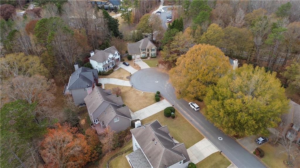 325 Morning Mist Walk Suwanee, GA 30024 - Photo 63 of 67 an aerial view of a house with a yard and lake view