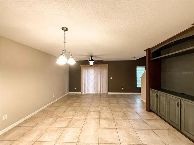 a view of a room with a sink and cabinets