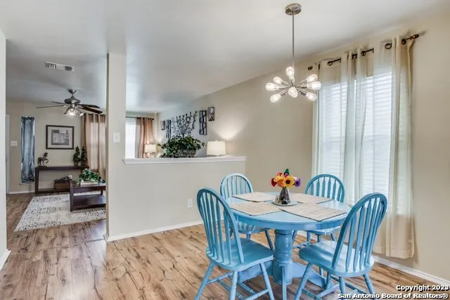 a view of a dining room with furniture wooden floor and chandelier
