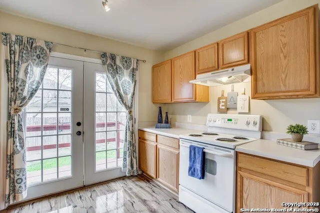 a kitchen with stainless steel appliances granite countertop a stove a sink and a refrigerator