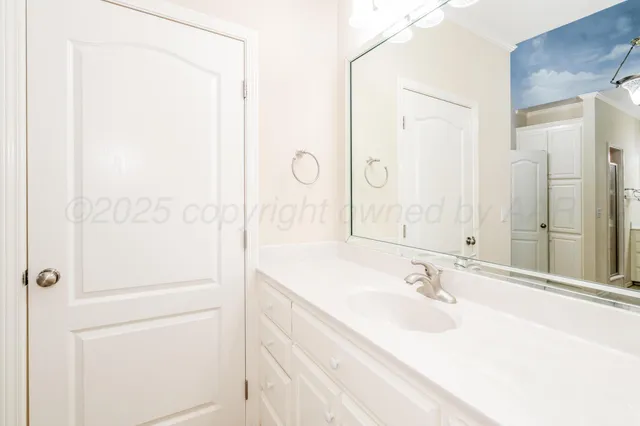 a spacious bathroom with a granite countertop sink a mirror and a bathtub