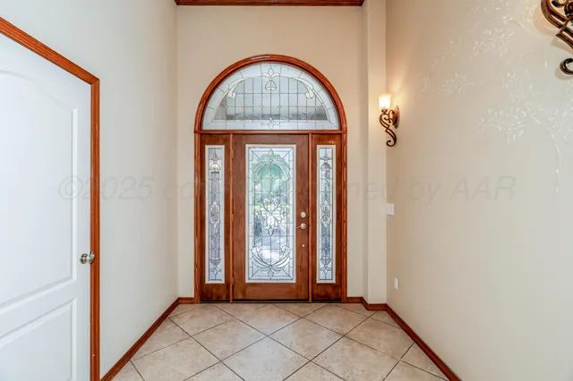 a view of an empty room with a fireplace and a window
