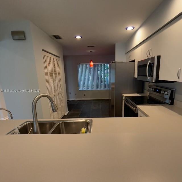 1683 Southwest 109th Terrace Davie, FL 33324 - Photo 23 of 45 a kitchen with kitchen island a sink stainless steel appliances and cabinets
