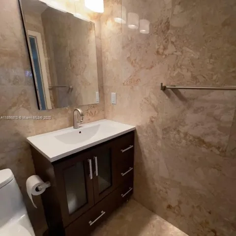 a bathroom with a shower and toilet