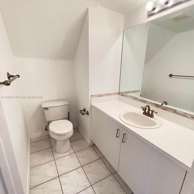 1683 Southwest 109th Terrace Davie, FL 33324 - Photo 38 of 45 a bathroom with a sink a toilet and a mirror