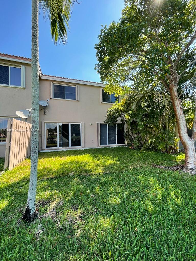 1683 Southwest 109th Terrace Davie, FL 33324 - Photo 5 of 45 a view of a house with backyard and a tree