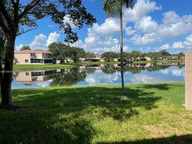 a view of a lake with a house in the background