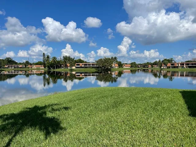 a view of a lake with houses in back