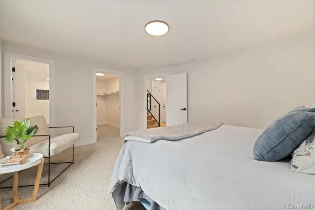 a bedroom with a bed and a couch