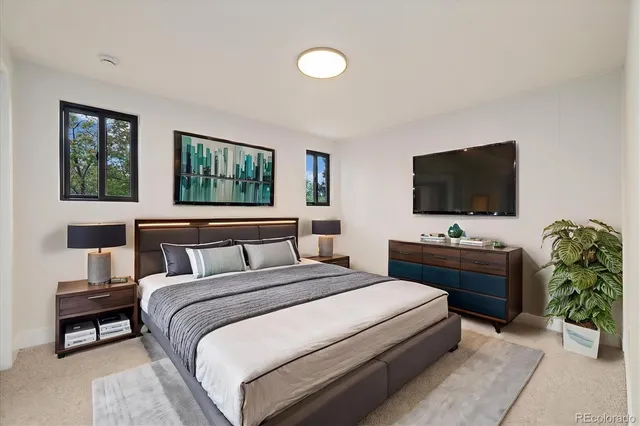 a bedroom with a bed and a flat screen tv