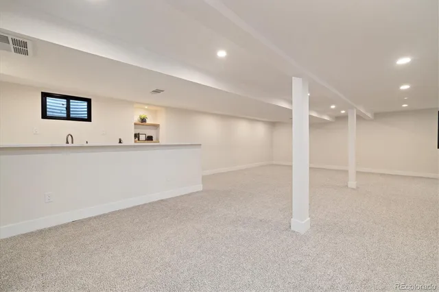 a view of a kitchen with a sink and a refrigerator