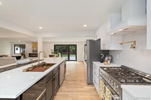 a kitchen with sink stove and cabinets