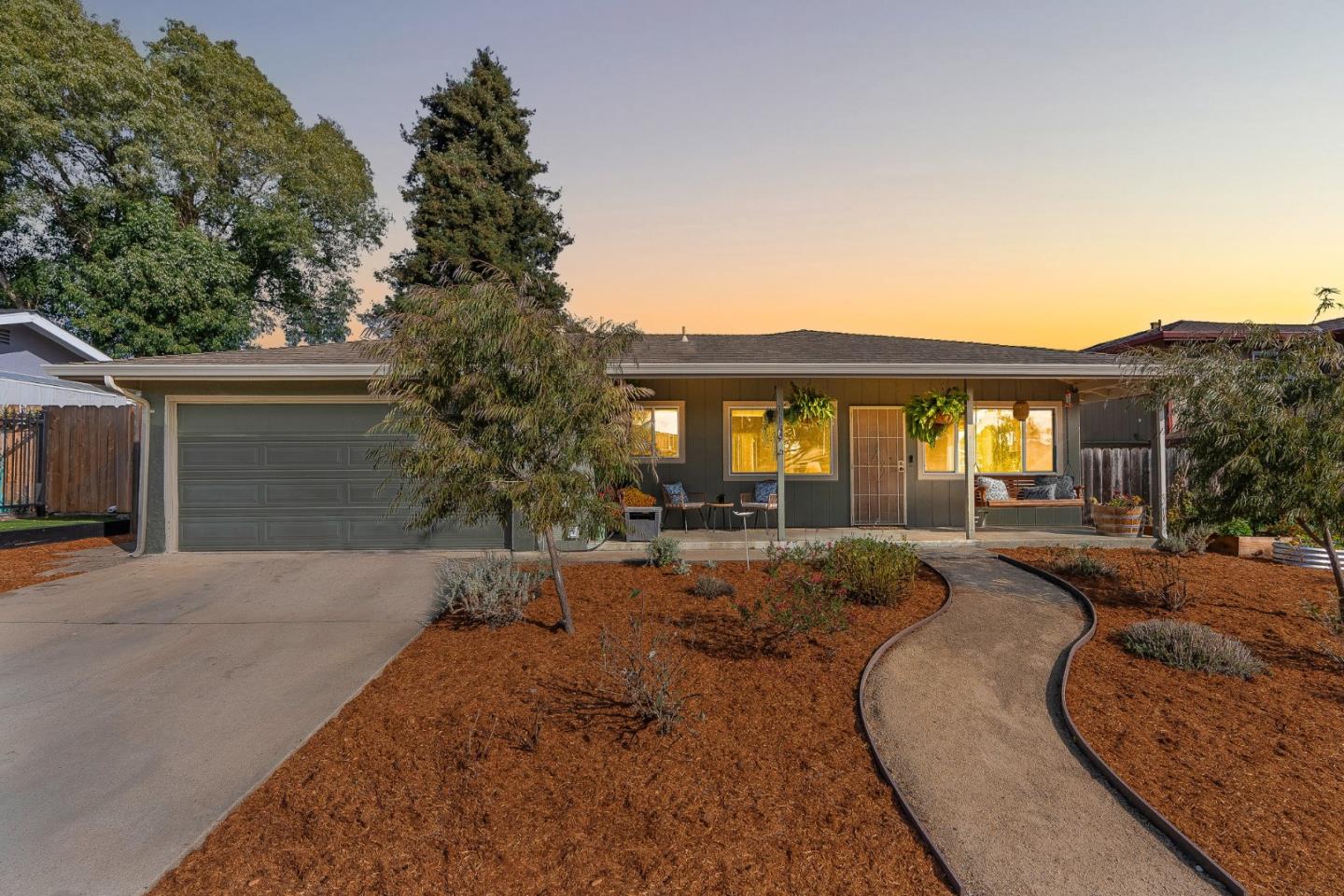 a view of a house with backyard and sitting area