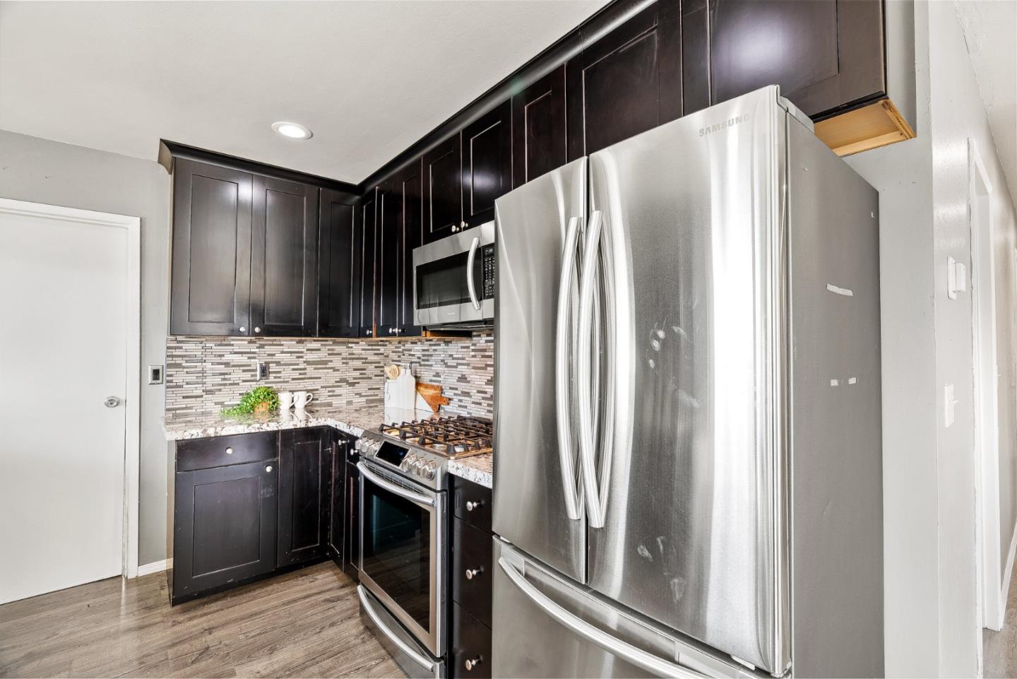 116 Lester Court Watsonville, CA 95076 - Photo 13 of 47 a kitchen with stainless steel appliances a refrigerator and a stove top oven