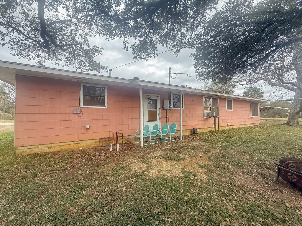729 Main Street Lexington, TX 78947 - Photo 12 of 15 Back of property featuring a lawn and a fire pit