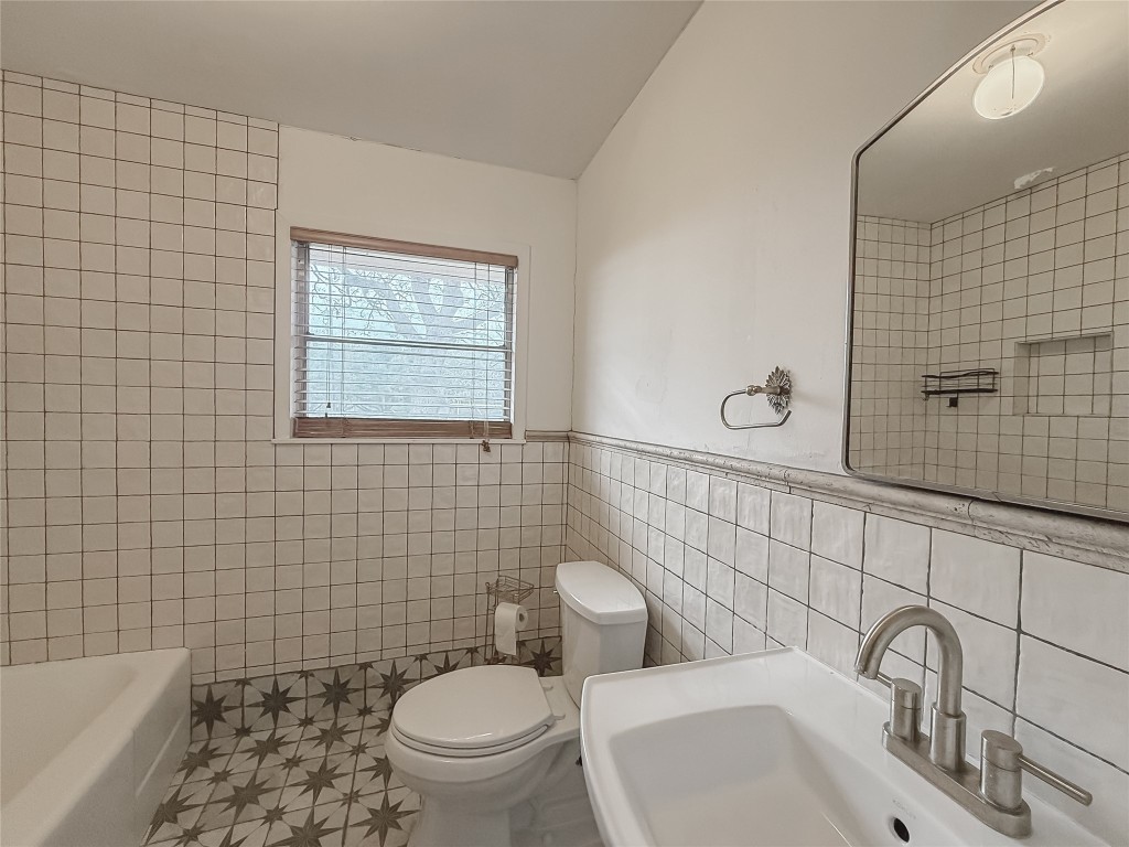 729 Main Street Lexington, TX 78947 - Photo 6 of 15 Full bathroom with tile walls and a wainscoted wall