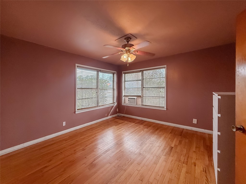 729 Main Street Lexington, TX 78947 - Photo 8 of 15 Empty room featuring light wood-type flooring, ceiling fan, and cooling unit