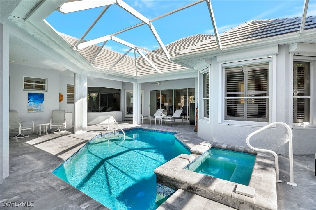 2450 Wulfert Road Sanibel, FL 33957 - Photo 7 of 44 a view of a patio with couches table and chairs under an umbrella