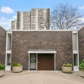 a front view of a building with potted plants