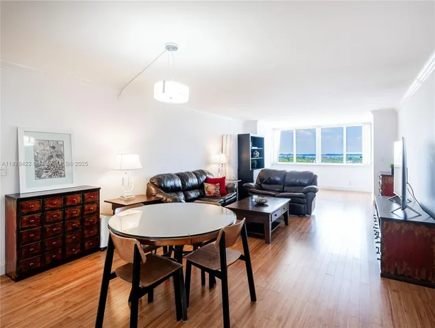 a view of a dining room with furniture and wooden floor