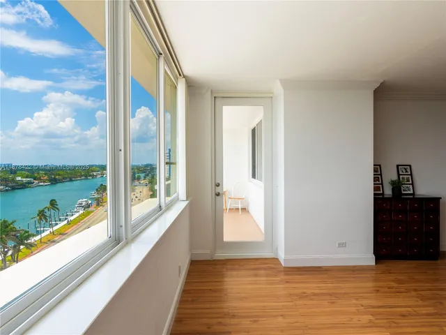 a view of an entryway with wooden floor and a lake view