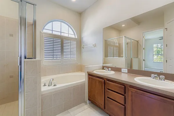 a bathroom with a granite countertop sink and a bathtub