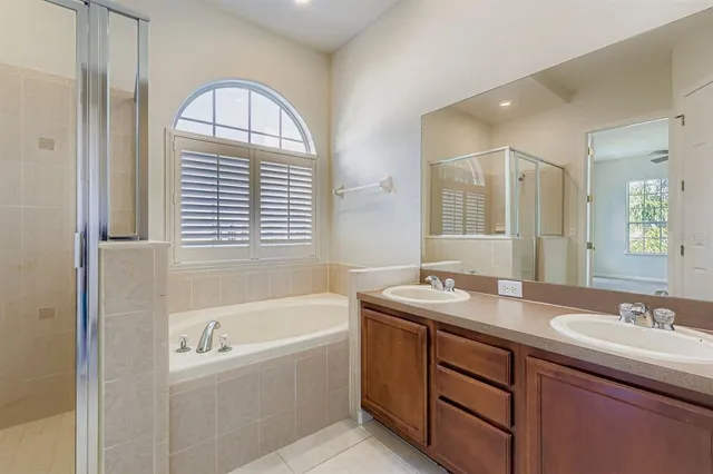 a bathroom with a granite countertop sink and a bathtub