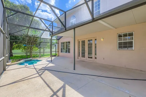 a view of a house with a porch and a yard