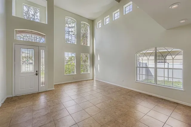 an empty room with windows and entrance