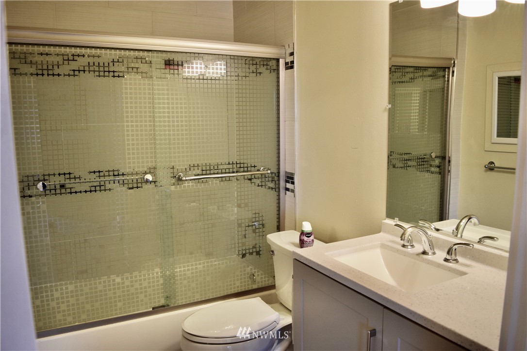 357 Lind Avenue Northwest Renton, WA 98057 - Photo 16 of 27 a bathroom with a sink a toilet and shower