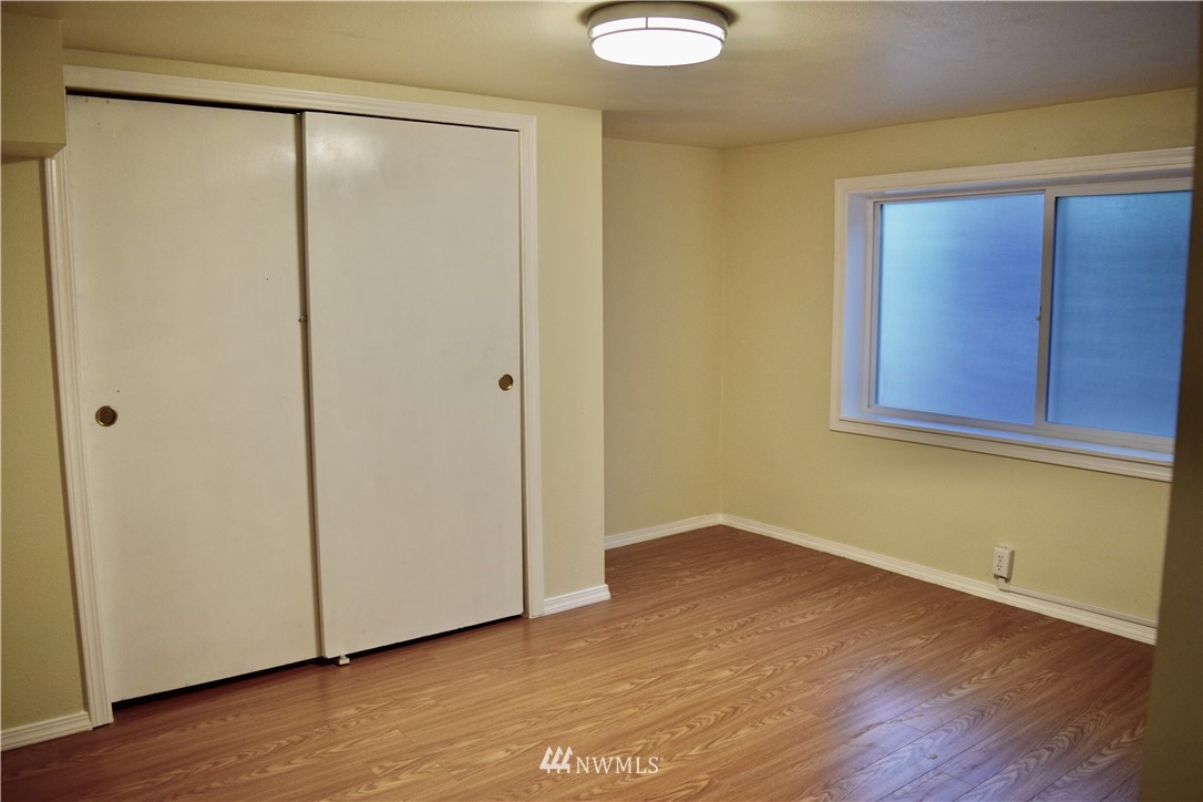 357 Lind Avenue Northwest Renton, WA 98057 - Photo 18 of 27 a view of an empty room with wooden floor and closet