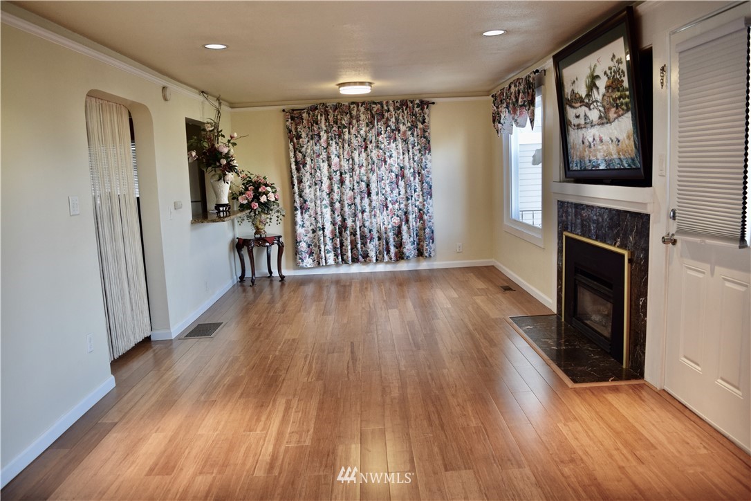 357 Lind Avenue Northwest Renton, WA 98057 - Photo 9 of 27 a view of livingroom with hardwood floor and a ceiling fan
