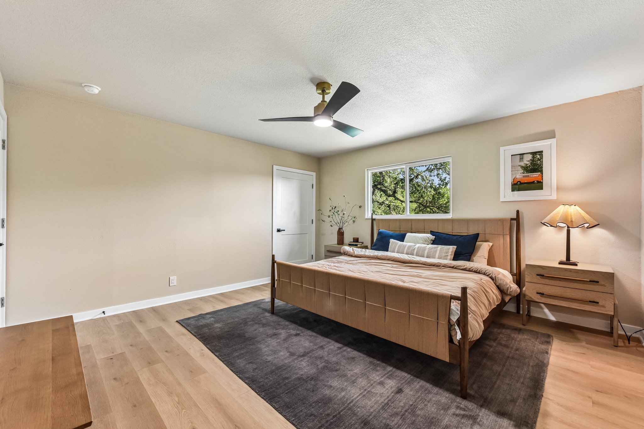 7523 Glenhill Road Austin, TX 78752 - Photo 17 of 38 Relax in a generously proportioned bedroom featuring wood flooring and a refreshing ceiling fan.