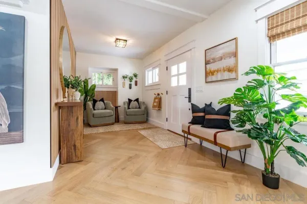 a dining hall with stainless steel appliances kitchen island granite countertop a table and chairs in it