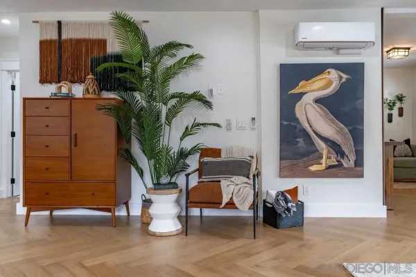a living room with furniture fireplace and potted plants