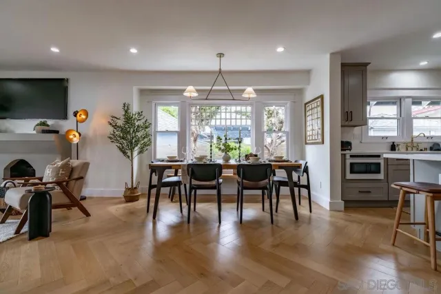 a living room with furniture a fireplace and a potted plant