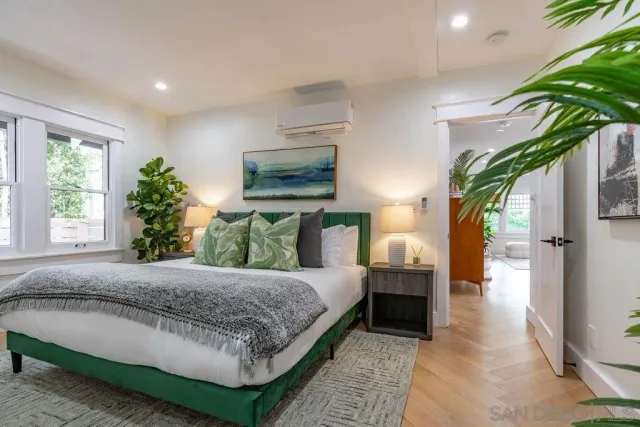 a bedroom with a bed and a night stand