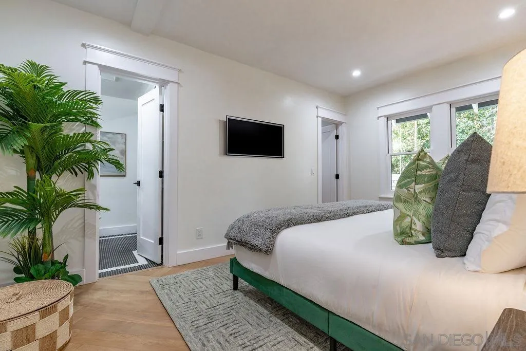 725 Pennsylvania Avenue San Diego, CA 92103 - Photo 32 of 64 a bedroom with a large bed and a potted plant