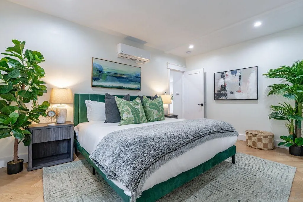 725 Pennsylvania Avenue San Diego, CA 92103 - Photo 33 of 64 a bedroom with a large bed and a potted plant