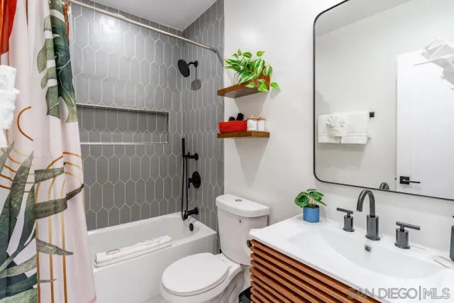a bedroom with a bed painting on wall and a potted plant
