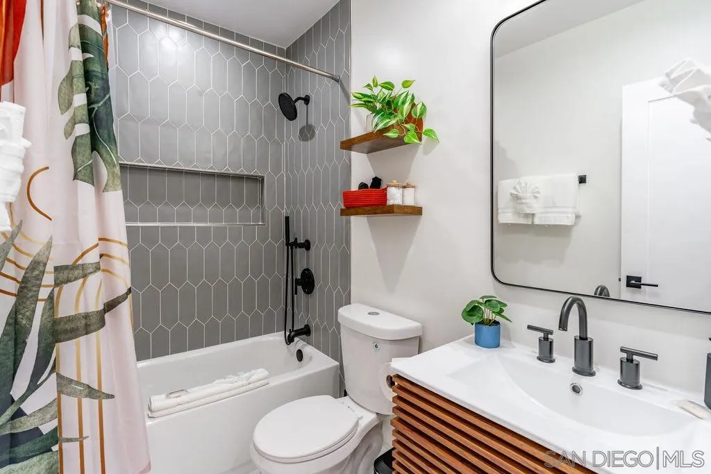 725 Pennsylvania Avenue San Diego, CA 92103 - Photo 36 of 64 a white toilet sitting next to a bathroom sink and tub