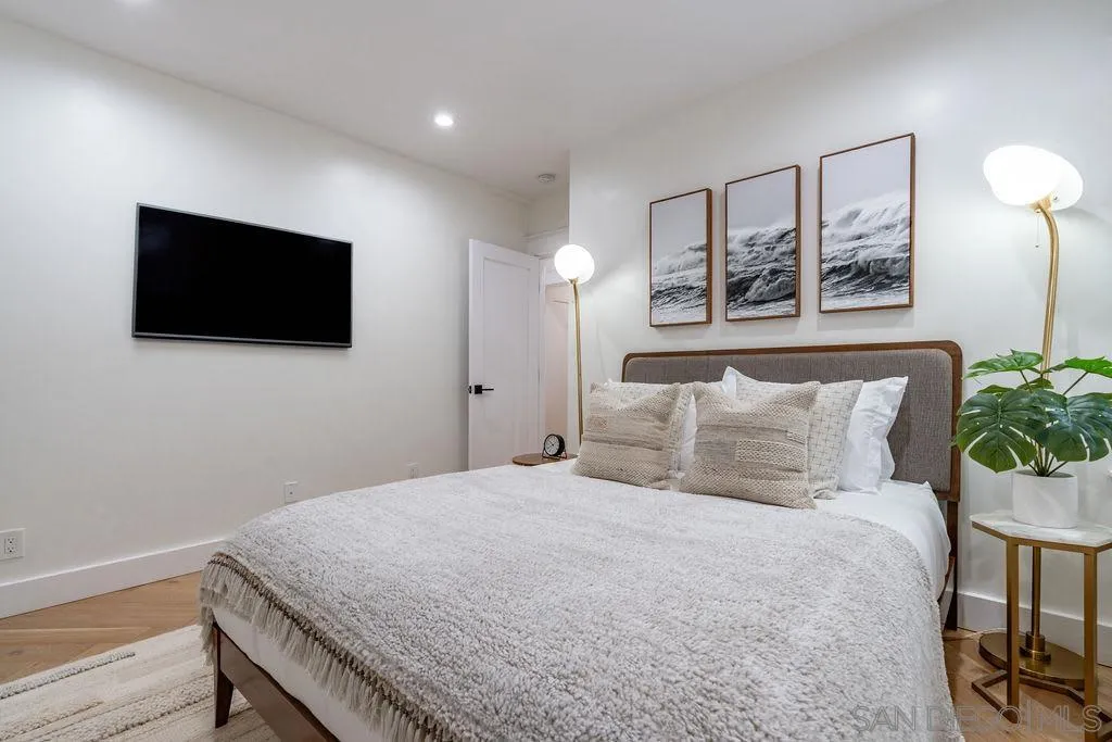 725 Pennsylvania Avenue San Diego, CA 92103 - Photo 38 of 64 a bedroom with a large bed and a flat screen tv
