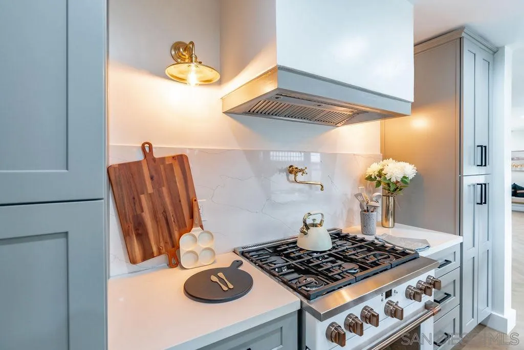 725 Pennsylvania Avenue San Diego, CA 92103 - Photo 4 of 64 a table with a stove and a wooden floor