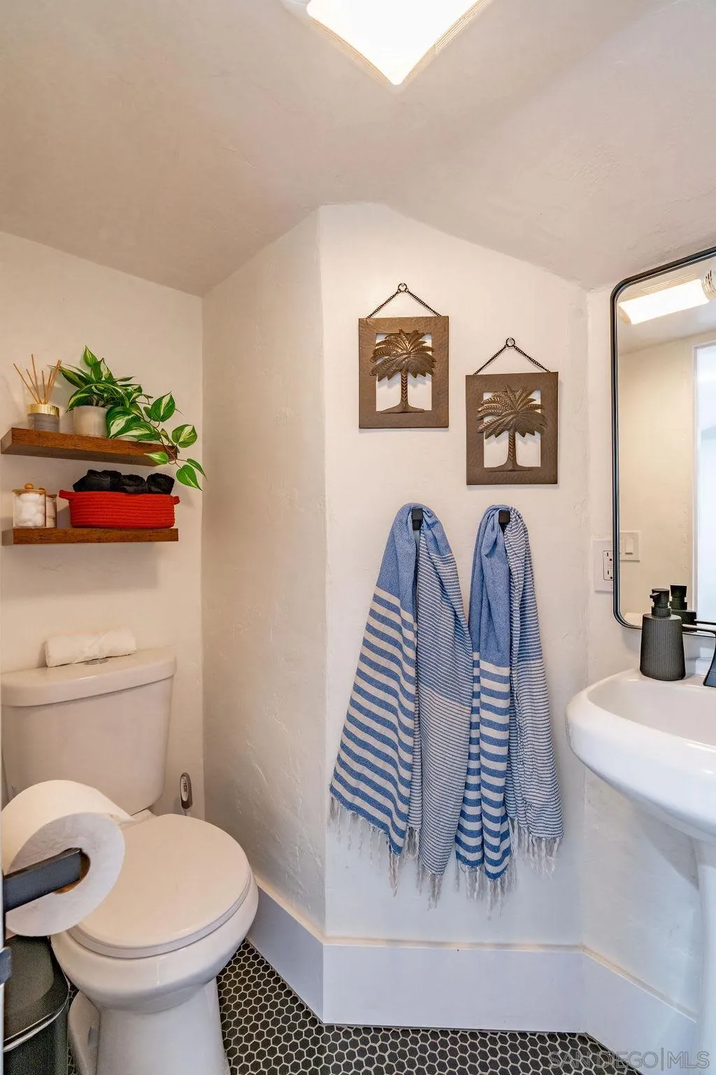 725 Pennsylvania Avenue San Diego, CA 92103 - Photo 57 of 64 a bathroom with a sink toilet and a mirror