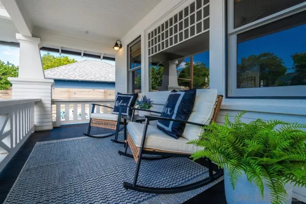 a wooden bench sitting in front of a house
