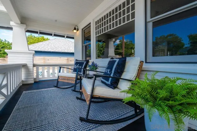 a wooden bench sitting in front of a house